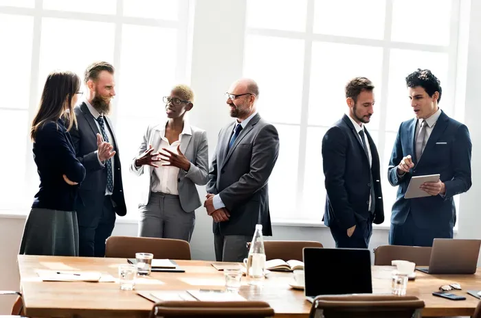Business professionals talking and collaborating during a networking session at the local business portal office